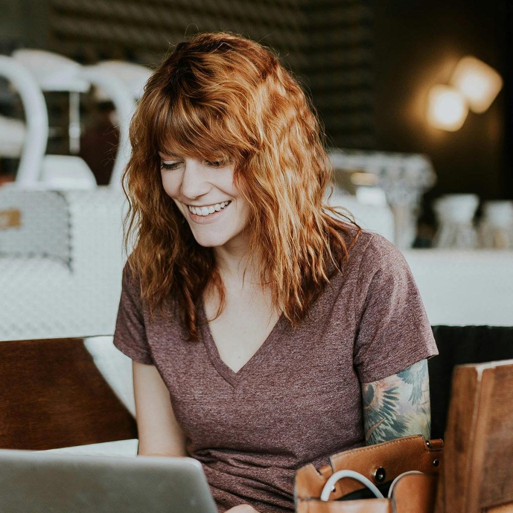 an adult learner working on a laptop in a public setting